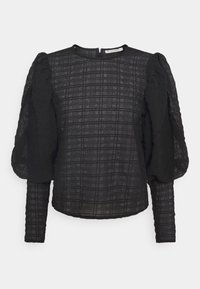 Czarna bluzka z długim rękawem, wykonana z teksturowanej tkaniny, z wzorem w kratę oraz marszczonymi bufiastymi rękawami. Wysoki dekolt i zapięcie z tyłu na środku.
