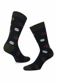 Granatowe skarpetki z motywami związanymi z biwakowaniem, takimi jak namioty, kompas i drzewa. Żebrowany zielony mankiet z wzmocnionym palcem i piętą dla większej trwałości.