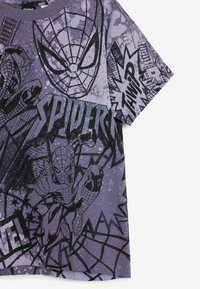 Purple short-sleeve T-shirt featuring Spider-Man graphics, black outlines, comic-style text, and a textured background with splatter effects.