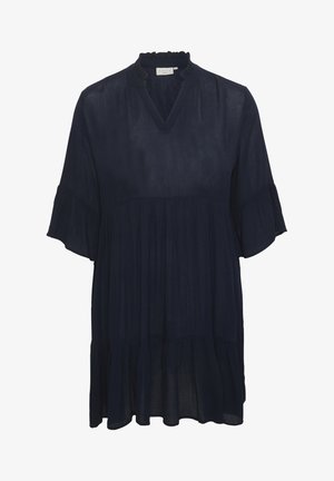 Robe bleu marine, taille ample, avec un décolleté à volants et des manches courtes évasées. Présente une jupe à volants, fluide, avec un léger éclat.