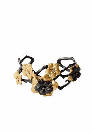 Pulsera con ramas entrelazadas negras y doradas decoradas con flores negras y doradas alternadas, algunas con pequeñas piedras transparentes.