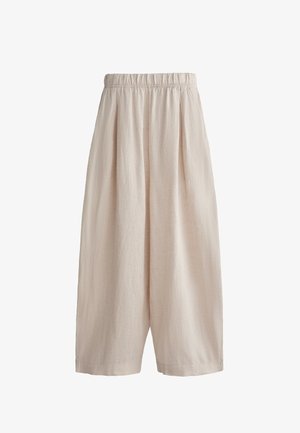 Lys beige culottebukser lavet af tekstureret stof. Har elastisk talje og brede ben, hvilket giver en afslappet silhuet.