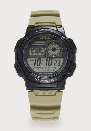 Montre numérique avec un boîtier noir et un bracelet en silicone beige. Les caractéristiques incluent un écran LCD, l'heure, la date et des fonctions d'alarme, ainsi que des boutons texturés.