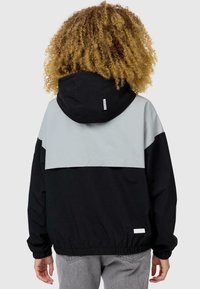 Black and light gray hooded jacket with elastic cuffs and hem, featuring a contrasting back panel and small logo tag on the bottom left.