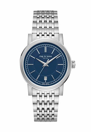 Montre-bracelet en métal argenté avec cadran bleu, index et aiguilles argentés, fenêtre de date à 6 heures, et marqué "rag & bone NEW YORK".