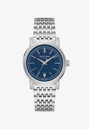 Silver metal wristwatch with blue dial, silver hour markers and hands, date window at 6 o'clock, and "rag & bone NEW YORK" branding.