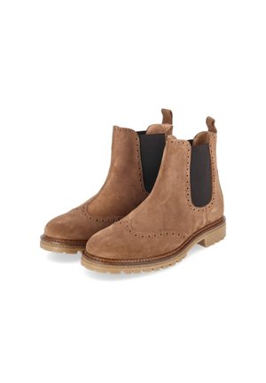 Paar bruine suède Chelsea boots met zwarte elastische zijpanelen en uittreklussen op lichtbruine rubberen zolen.