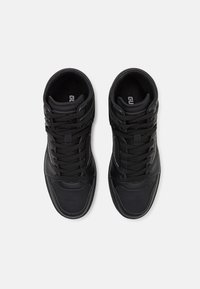 Black high-top sneakers with a textured surface, prominent lacing system, perforated toe area, and minimal white accents on the sides.