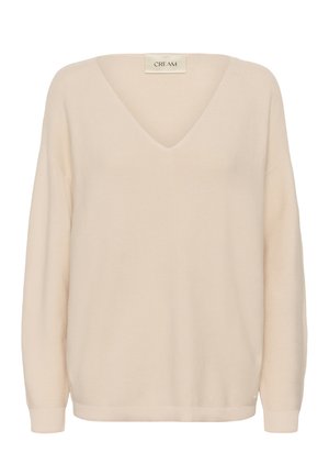 Gebreide trui in roomkleur met een V-hals, lange mouwen en geribbelde manchetten. De stof heeft een gestructureerde afwerking, wat zorgt voor een zachte uitstraling.