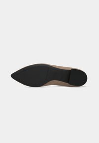 Beige suede stiletto heel with a pointed toe. Black rubber sole for grip, smooth texture with minimal detailing. Elegant shape design.
