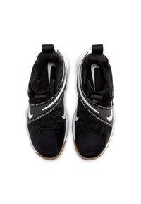 Scarpe sportive nere con tomaia in tessuto texturizzato, suola in gomma e logo Nike bianco. Presenta una suola intermedia stampata e cinturini regolabili.