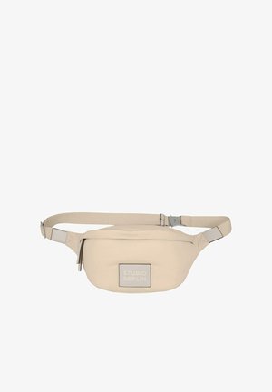 Béžová ľadvinka vyrobená z mäkkého materiálu, s obdĺžnikovým hlavným priestorom, nastaviteľným popruhom a štítkom s logom "STUDIO BERLIN".