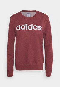 Sweat-shirt Adidas bordeaux à col ras du cou, manches longues, avec logo Adidas blanc centré sur la poitrine.