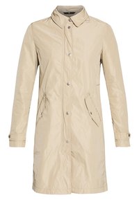 Manteau imperméable beige avec un col pointu, des boutons pression, deux poches latérales et des poignets réglables. Texture lisse avec une coupe droite.