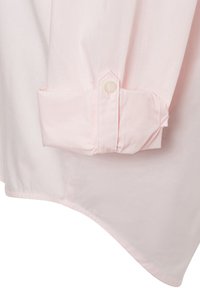 Camicia a maniche lunghe rosa chiaro con polsini a bottone, texture liscia e orlo leggermente curvato per una vestibilità rilassata.