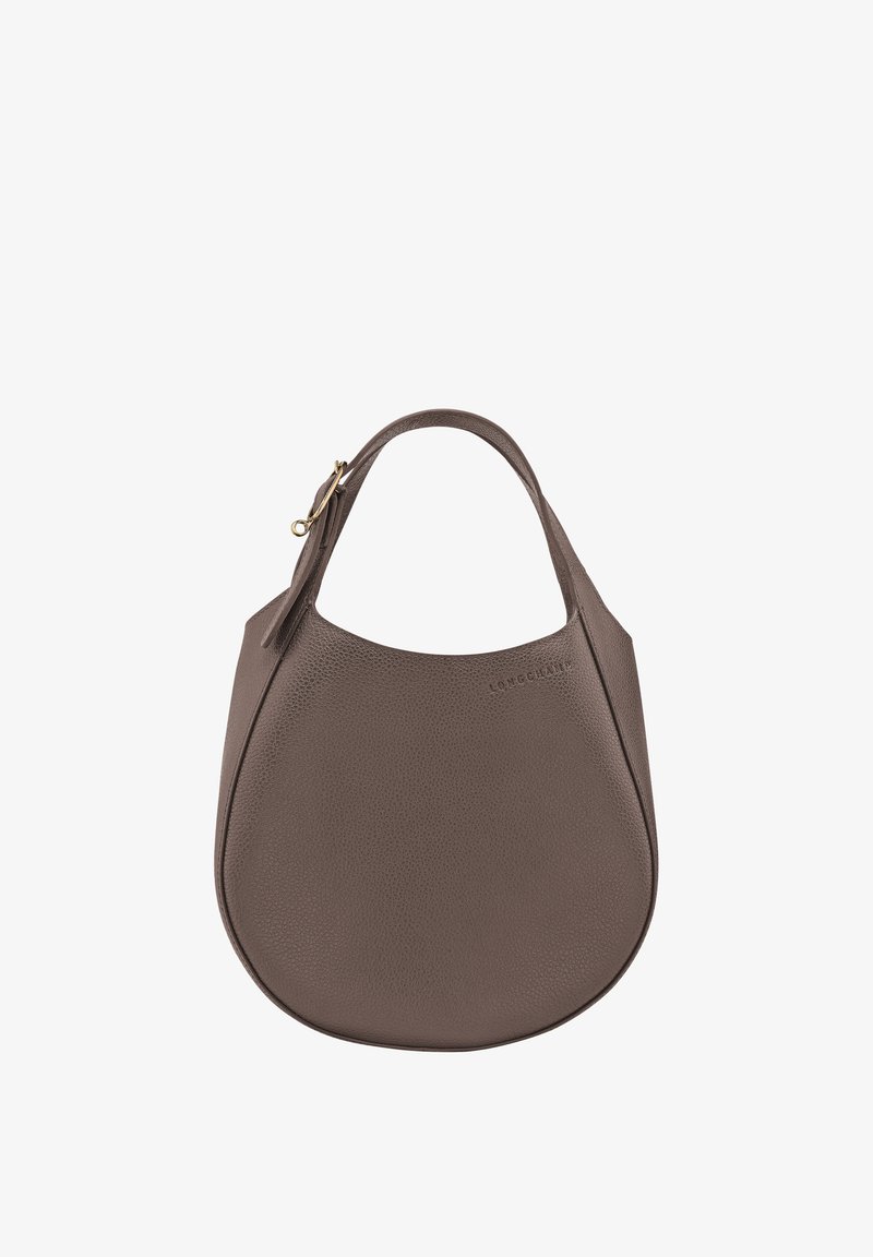 Brown leather handbag with a smooth texture, curved shape, short handle, and a gold-tone zip closure. Features embossed logo on the side.