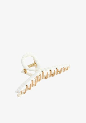 White hair claw made of plastic with a textured, woven finish. Features gold-tone metal hardware and a looped design for secure hold.