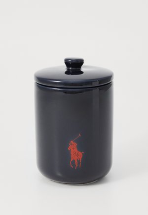 Vaso in ceramica navy con finitura lucida, di forma cilindrica e con coperchio coordinato. Presenta un logo di un giocatore di polo rosso sul davanti.