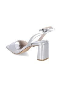 Sølv højhælet sandal med spids tå, blokhæl og ankelrem med metalspænde på hvid baggrund.