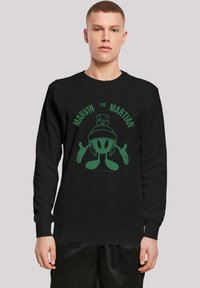 Felpa nera con una grafica verde di Marvin il Marziano, con il testo "MARVIN IL MARZIANO" sopra il personaggio in un layout circolare.