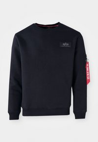 Donkerblauwe sweatshirt gemaakt van een katoenmix met een ronde hals, ribgebreide manchet en een met rits afsluitbare mouwzak met een rode label.