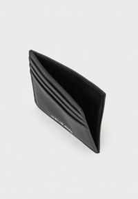 Portafoglio in pelle nera con quattro slot per carte e un compartimento centrale per contanti, inclinato su uno sfondo bianco.
