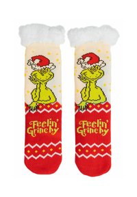 Un paio di calze natalizie rosse e crema con il Grinch che indossa un cappello di Babbo Natale e la scritta "Sentendomi Grinch" con risvolti bianchi e pelosi.