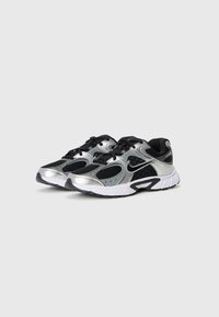 Silver and black athletic shoes with mesh and synthetic material, featuring a textured surface, white sole, and black laces.