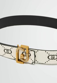 Curea albă din piele cu model negru, cataramă aurie cu strasuri și un design de închidere. Spate negru, textură netedă, formă rectangulară.