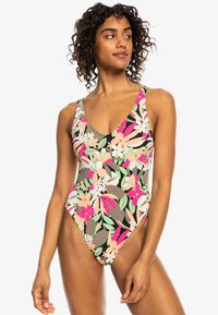 Maillot de bain une pièce avec un imprimé floral vibrant dans des tons de rose, vert et crème. Le tissu semble lisse avec un décolleté en V plongeant.
