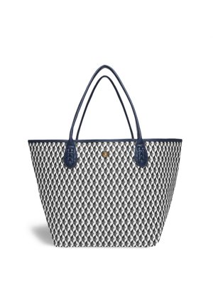 Nákupní taška s geometrickým černobílým vzorem, námořnickými modrými popruhy a tkanou texturou. Obsahuje zlaté logo uprostřed.