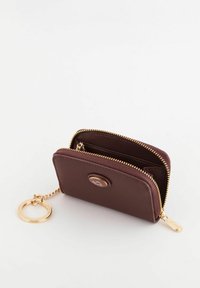 Brown textured leather wallet with gold hardware, featuring a zip closure, keychain attachment, and interior compartments for cards and cash.