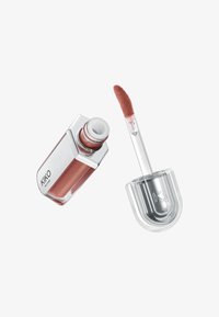 Liquid lipstick in a clear glass tube with a silver accent, featuring a soft applicator tip. Color is a warm, muted rose with shimmer.
