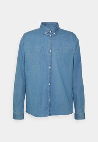 Camisa de mezclilla azul claro con mangas largas, cierre de botones en el frente, dos bolsillos en el pecho y cuello tipo extendido. Tela texturizada y diseño clásico.