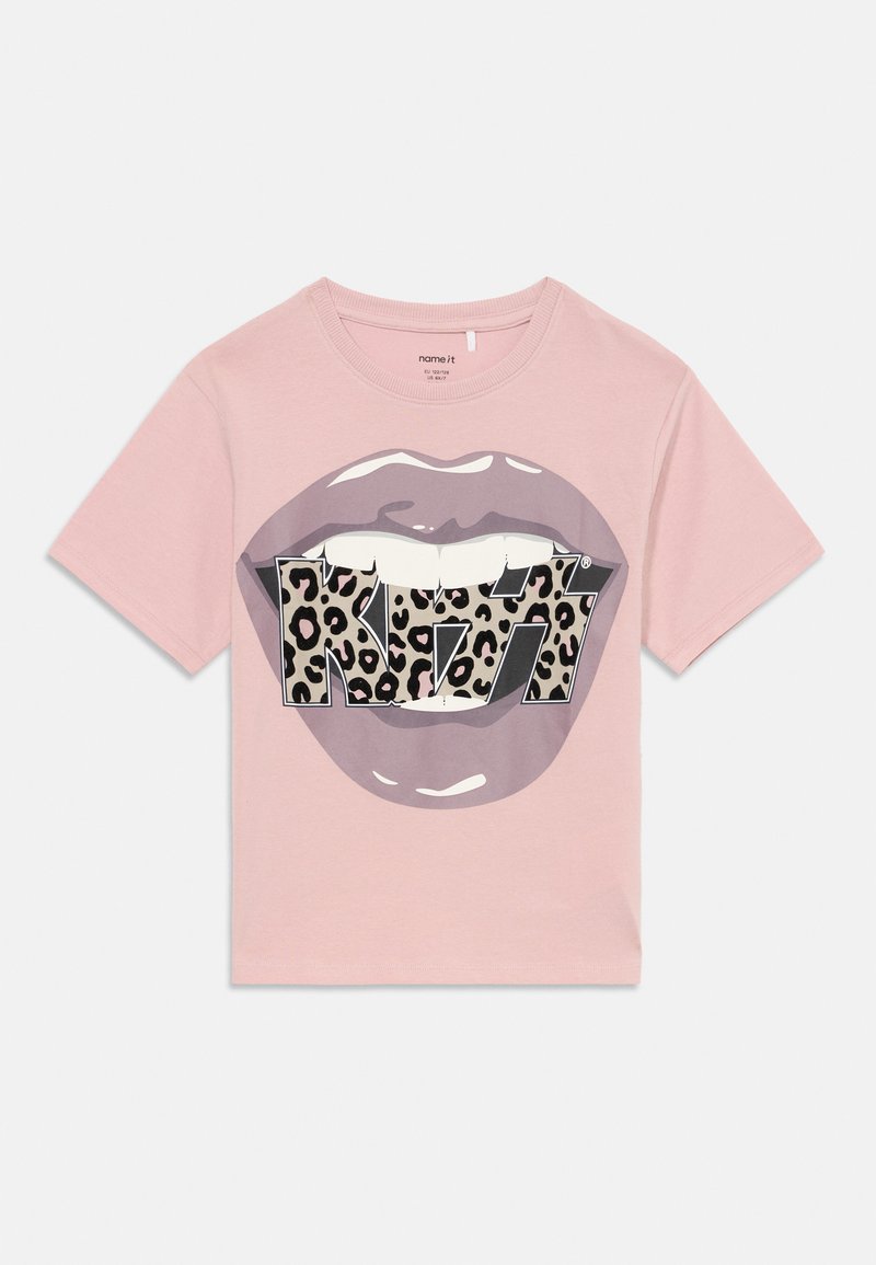 Lyse rosa kortermet t-skjorte med grafikk av lilla lepper og leopardmønsteret "KISS" tekst over tannområdet på forsiden.