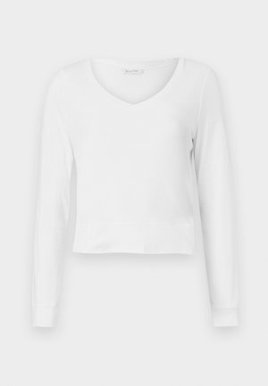 Camisola cropped de manga longa branca com decote em V, de design ajustado e punhos largos, apresentada sobre um fundo simples.