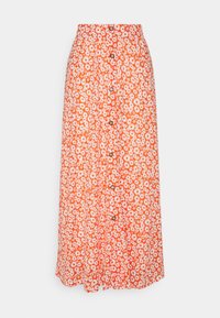 Jupe maxi florale avec un fond orange vif, des marguerites blanches et des boutons sur le devant. Tissu léger, design fluide.