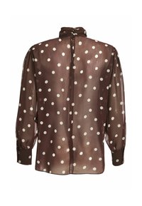 Blouse marron transparente à pois blancs, manches longues bouffantes, col haut avec fermeture par bouton au dos.