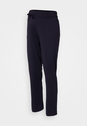 Námornícke modré tepláky s širokým elastickým pásom a nastaviteľnou šnúrkou. Vyrobené z mäkkej zmesi bavlny, s rovnými nohavicami.