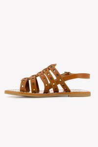 Tan leather sandals with crisscross straps, featuring gold star accents and a flat sole. Open design for breathability and comfort.