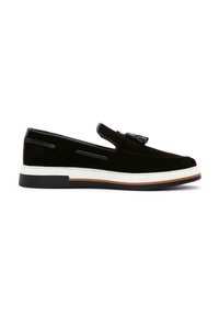 Black suede slip-on shoe with a white rubber sole, featuring side cutouts and a small decorative element on the upper.
