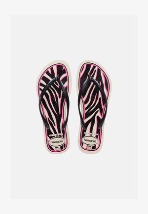 Par par Havaianas-klipklappere med sorte og pink zebrastriber, sorte remme og størrelsesetiketter synlige på beige såler.