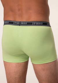 Slip verdi in cotone con una vita in nero logo, caratterizzati da un design aderente e una consistenza liscia. Adatti per l'uso quotidiano.