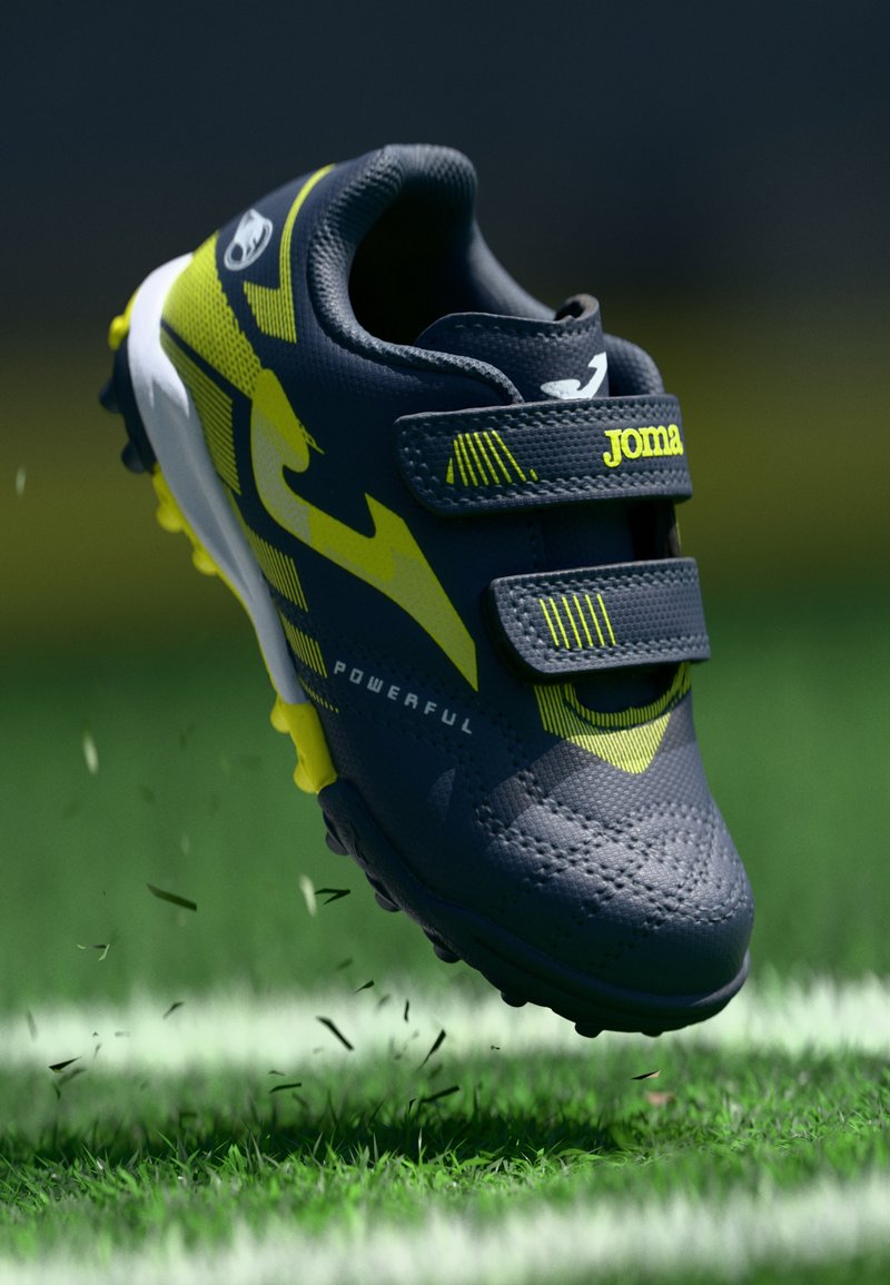 Αθλητικά παπούτσια με σκούρο γκρι συνθετικό επάνω μέρος, νέον κίτρινες λεπτομέρειες, δύο λωρίδες βέλκρο, υφασμάτινη επιφάνεια και καλουπωτή σόλα για πρόσφυση.