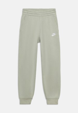 Pantalon de survêtement Nike vert clair avec taille élastique, poches latérales, chevilles resserrées et logo Nike blanc sur la cuisse gauche.