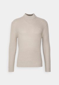 Ljusbeige stickad tröja med långa ärmar och en hög krage, med en texturerad ribbad mönstring.