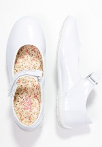 Witte gepatineerde leren schoenen met een ronde neus, verstelbare band en een interieur met bloemenpatroon. Gladde textuur met een rubberen zool.