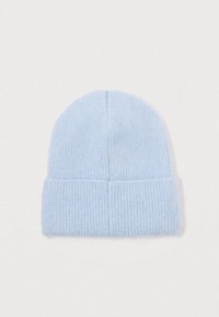 Light blue ribbed knit beanie with folded cuff, laid flat on a white background.