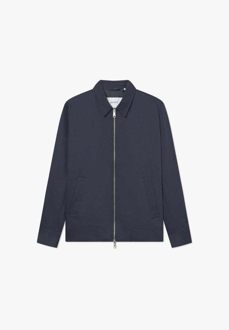 Marineblå hettejakke med glidelås, krage, to sidelommer og en jevn stofffinish. Sølvglidelås med minimale sømdetaljer.