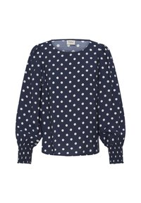 Blouse bleu marine à manches longues avec des pois blancs, col rond, manches bouffantes et poignets froncés.